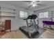 Spacious workout room featuring a treadmill, weight bench, shelves, and hardwood floors at 343 E Waterbury Rd, Indianapolis, IN 46227