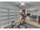 Treadmill in a versatile workout room with hardwood floors and built-in shelving and desk at 343 E Waterbury Rd, Indianapolis, IN 46227