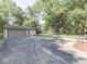Detached two car garage with an adjacent patio area and large yard at 343 E Waterbury Rd, Indianapolis, IN 46227