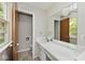 Bathroom featuring a vanity, a large mirror, and a door to another room at 3545 Whippoorwill Lake N Dr, Monrovia, IN 46157