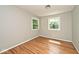 Bright bedroom features hardwood floors and two windows overlooking the outside at 3545 Whippoorwill Lake N Dr, Monrovia, IN 46157
