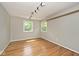 Empty bedroom with hardwood floors, neutral paint and two windows at 3545 Whippoorwill Lake N Dr, Monrovia, IN 46157