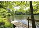 A picturesque dock on a calm lake, surrounded by lush trees and foliage at 3545 Whippoorwill Lake N Dr, Monrovia, IN 46157
