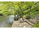 A serene dock on a tree-lined lake with a built-in bench for relaxation at 3545 Whippoorwill Lake N Dr, Monrovia, IN 46157