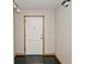 Entryway with white door, oak trim and black tile flooring at 3545 Whippoorwill Lake N Dr, Monrovia, IN 46157