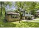 Two-story home with brick accents and a three-car garage surrounded by lush greenery at 3545 Whippoorwill Lake N Dr, Monrovia, IN 46157