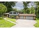Two-story home with brick accents and a three-car garage surrounded by lush greenery at 3545 Whippoorwill Lake N Dr, Monrovia, IN 46157