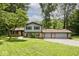 Two-story home with brick accents and a three-car garage surrounded by lush greenery at 3545 Whippoorwill Lake N Dr, Monrovia, IN 46157