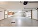 Spacious garage features light gray floor and white walls and natural light at 3545 Whippoorwill Lake N Dr, Monrovia, IN 46157
