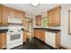 Kitchen with wood cabinets, black counters, and black tile flooring at 3545 Whippoorwill Lake N Dr, Monrovia, IN 46157