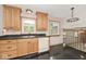 Kitchen with wood cabinets, black counters, and black tile flooring at 3545 Whippoorwill Lake N Dr, Monrovia, IN 46157
