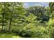 Tranquil lake view framed by lush greenery and a charming wooden fence at 3545 Whippoorwill Lake N Dr, Monrovia, IN 46157