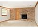 Living room with brick fireplace, carpet and wood trim at 3545 Whippoorwill Lake N Dr, Monrovia, IN 46157