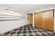 Bonus room featuring checkered tile, shelving and a storage closet at 3545 Whippoorwill Lake N Dr, Monrovia, IN 46157