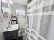 Functional bathroom featuring vanity sink, large mirror, and tub with shower at 3613 N Locust St, Muncie, IN 47304