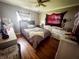 Comfortable bedroom featuring neutral tones, hardwood floors, and a ceiling fan at 3613 N Locust St, Muncie, IN 47304
