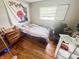 Cozy bedroom showcasing hardwood floors, large window and comfortable furnishings at 3613 N Locust St, Muncie, IN 47304