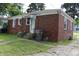 Single story brick home with white trim, a small front porch, and a well kept lawn at 3616 N Dearborn St, Indianapolis, IN 46218