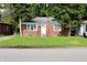 Cozy single-story brick home with a well-maintained lawn and mature trees in a residential neighborhood at 3616 N Dearborn St, Indianapolis, IN 46218
