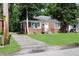 Quaint brick home with a driveway and lush green lawn in a quiet neighborhood setting at 3616 N Dearborn St, Indianapolis, IN 46218