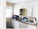 Functional kitchen featuring white cabinetry, window, and ample counter space for meal preparation at 3616 N Dearborn St, Indianapolis, IN 46218