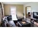 Warm living area with a leather sofa, accent pillows, modern flooring and connecting dining area at 3616 N Dearborn St, Indianapolis, IN 46218