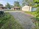 View of the property's garage, driveway, and house from the rear yard at 3845 N Irvington Ave, Indianapolis, IN 46226