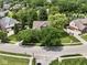 Aerial view of a suburban home nestled amongst mature trees and landscaped yards at 4084 Mountbatton Dr, Greenwood, IN 46143