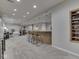 Stylish basement featuring bar seating, built in shelving, and open recreational space with a calming aesthetic at 4084 Mountbatton Dr, Greenwood, IN 46143