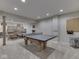 Finished basement area with a ping pong table, and seating area in the background at 4084 Mountbatton Dr, Greenwood, IN 46143