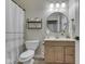 Bathroom with round mirror, updated vanity, and neutral tile is a functional and stylish space at 4084 Mountbatton Dr, Greenwood, IN 46143
