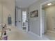 Well-lit bathroom with double sinks and doorway views to the main bedroom and shower area at 4084 Mountbatton Dr, Greenwood, IN 46143