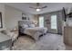 Brightly lit bedroom featuring a bed, sitting chair, and large windows at 4084 Mountbatton Dr, Greenwood, IN 46143