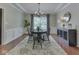 Elegant dining room featuring decorative trim, chandelier, and a large window with curtains at 4084 Mountbatton Dr, Greenwood, IN 46143