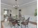 Elegant dining room featuring decorative trim, chandelier, and a large window with curtains at 4084 Mountbatton Dr, Greenwood, IN 46143