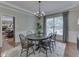 Elegant dining room featuring decorative trim, chandelier, and a large window with curtains at 4084 Mountbatton Dr, Greenwood, IN 46143