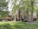 Beautiful two-story brick home with mature trees and lush landscaping at 4084 Mountbatton Dr, Greenwood, IN 46143