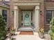 Inviting entryway with elegant columns, potted plants, and a welcoming wreath at 4084 Mountbatton Dr, Greenwood, IN 46143