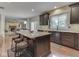 Well-lit kitchen features a central island with barstool seating and modern appliances at 4084 Mountbatton Dr, Greenwood, IN 46143