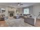 Bright living room features a fireplace, plush furniture, neutral tones, and plenty of natural light at 4084 Mountbatton Dr, Greenwood, IN 46143