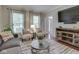 Cozy living room with a patterned rug, comfortable seating, and natural light from two windows at 4084 Mountbatton Dr, Greenwood, IN 46143