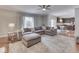 Open-concept living room with hardwood floors, a sectional sofa, and view into the kitchen at 4084 Mountbatton Dr, Greenwood, IN 46143