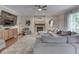 Comfortable living room with a stacked stone fireplace, ceiling fan, and plush sectional sofa at 4084 Mountbatton Dr, Greenwood, IN 46143