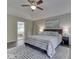 Main bedroom with plush carpeting, tray ceiling, and adjacent bathroom at 4084 Mountbatton Dr, Greenwood, IN 46143
