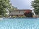 Inviting backyard with a clear blue pool, complemented by lush greenery and a well-manicured lawn at 4084 Mountbatton Dr, Greenwood, IN 46143