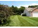 Spacious backyard with meticulously maintained lawn and adjacent shed for extra storage at 413 Blue Spring Dr, Indianapolis, IN 46239