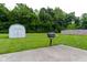 Backyard featuring a storage shed, BBQ, and flat concrete patio, offers outdoor conveniences at 413 Blue Spring Dr, Indianapolis, IN 46239