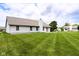 Wide open backyard with well-maintained lawn and white house, perfect for outdoor activities at 413 Blue Spring Dr, Indianapolis, IN 46239