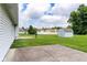 Spacious backyard featuring a patio, shed, and well-maintained lawn, perfect for outdoor activities at 413 Blue Spring Dr, Indianapolis, IN 46239