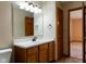 Bright bathroom featuring a white vanity with a dark faucet and tile flooring, as well as an adjacent room at 413 Blue Spring Dr, Indianapolis, IN 46239